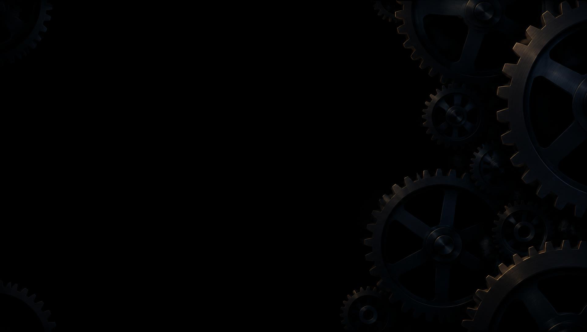 Dark mechanical gear cogs on a pure black background